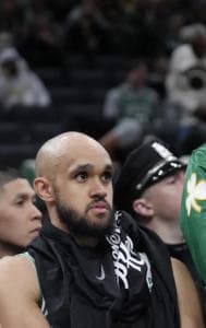 Boston Celtics' Payton Pritchard, Derrick White and Kristaps Porzingis watch their team struggle 
